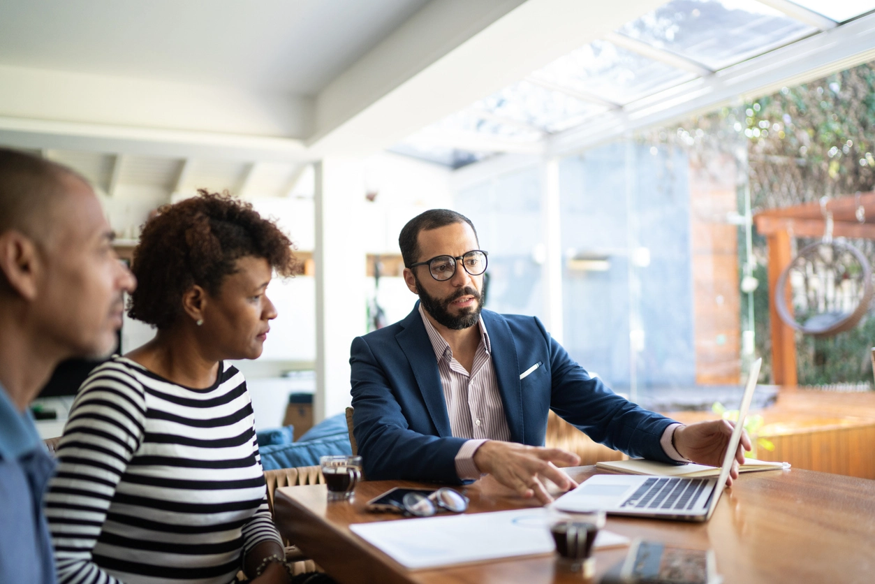 A couple meeting with a real estate agent.